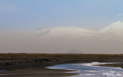 The Glacier Volcano Hekla seen in the sand mist with river in front