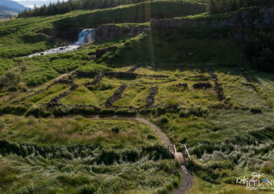 Old sheep round up made out of stones, seen from air in summertime with lot of green gras all around..