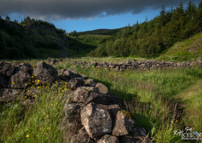 Old sheep round up made out of stones, seen from air in summertime with lot of green gras all around..