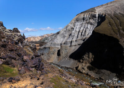 A stunning Icelandic mountain landscape with a flowing river winding through the valley below