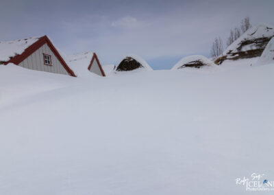 A picturesque snow-covered historic farm house in Iceland, highlighting the beauty of winter's pristine white blanket