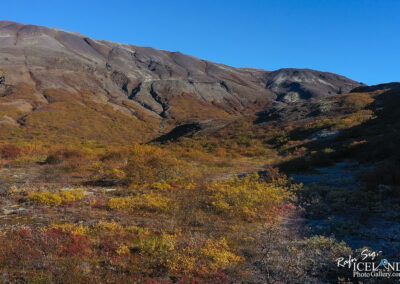 Majestic mountains draped in brilliant fall foliage, highlighting the rich colors of autumn in a serene outdoor setting.