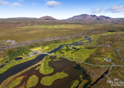 Scenic aerial perspective of a river flowing through rugged mountains, highlighting the beauty of nature.