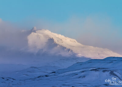 A majestic snowy mountain under a clear blue sky, showcasing the beauty of winter landscapes.